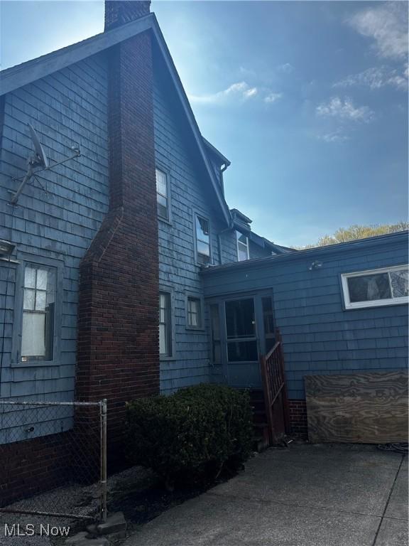 view of property exterior with a chimney