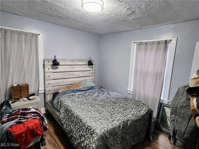 bedroom with wood finished floors and a textured ceiling