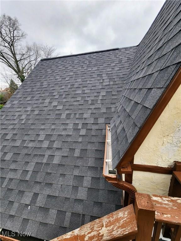 exterior details with roof with shingles