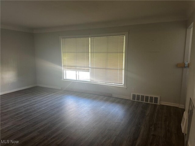 1765 E 238th St, Euclid, OH 44117 - spare room featuring dark wood-style floors, visible vents, and baseboards