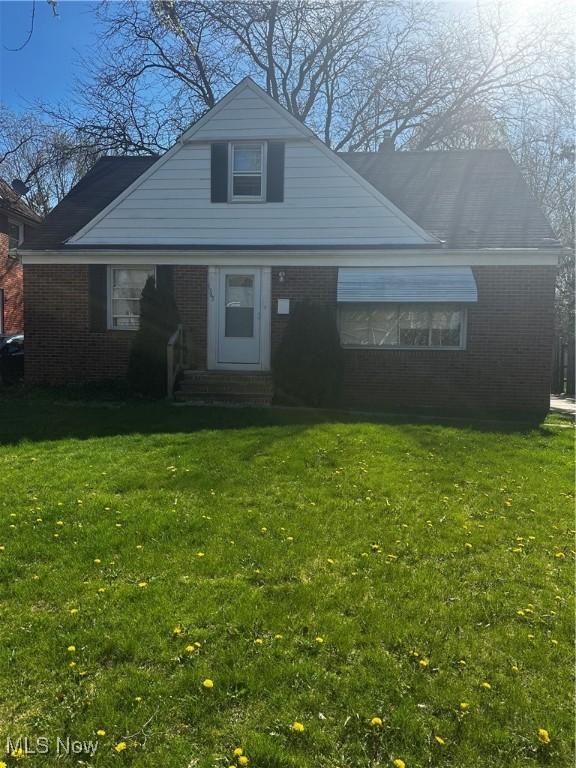 1765 E 238th St, Euclid, OH 44117 - bungalow featuring brick siding, entry steps, and a front yard