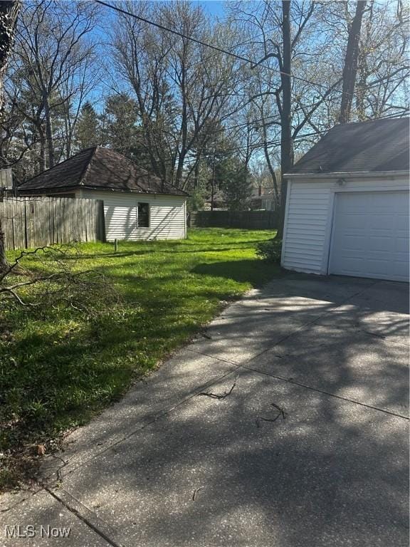 1765 E 238th St, Euclid, OH 44117 - view of yard with fence, an outdoor structure, and driveway