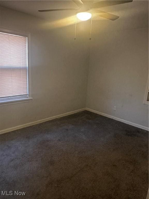 1765 E 238th St, Euclid, OH 44117 - empty room featuring a ceiling fan, dark carpet, and baseboards