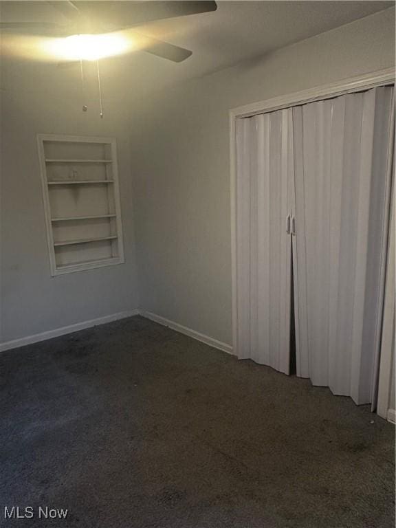 1765 E 238th St, Euclid, OH 44117 - unfurnished bedroom featuring baseboards, dark colored carpet, ceiling fan, and a closet