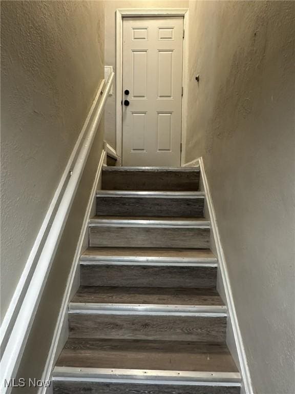 stairs with a textured wall