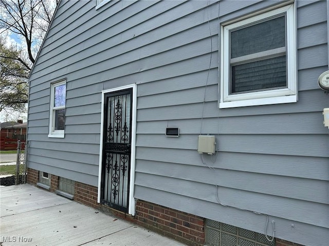 view of exterior entry with a deck