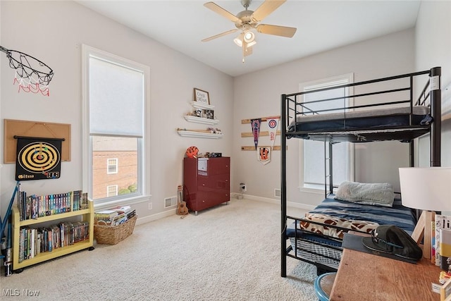 bedroom featuring baseboards, visible vents, ceiling fan, and carpet floors