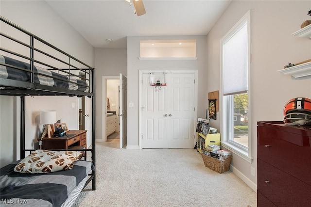 bedroom featuring a closet, a ceiling fan, carpet, and baseboards