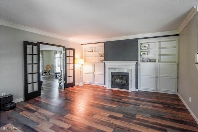 unfurnished living room featuring dark wood-style flooring, french doors, and crown molding