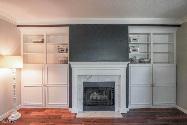 unfurnished living room with ornamental molding, a high end fireplace, and wood finished floors