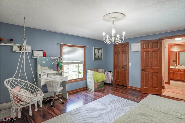 bedroom featuring a sink, a chandelier, baseboards, radiator heating unit, and wood finished floors