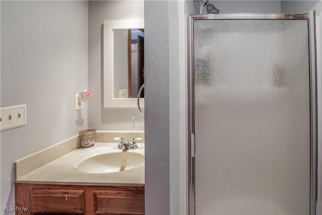 full bath with a shower stall and vanity