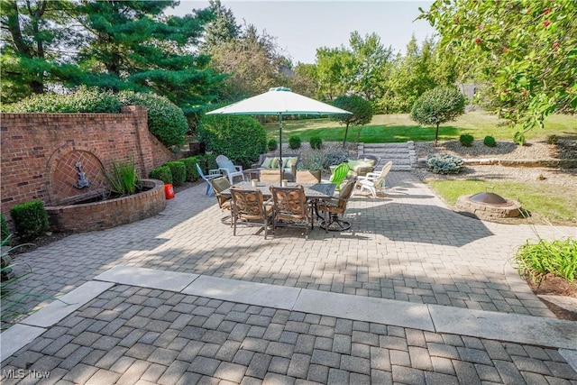 view of patio / terrace with outdoor dining space and an outdoor fire pit
