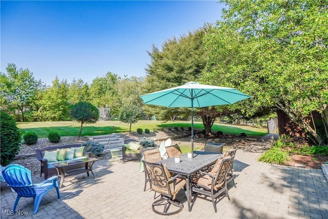 view of patio / terrace with outdoor dining space and an outdoor hangout area
