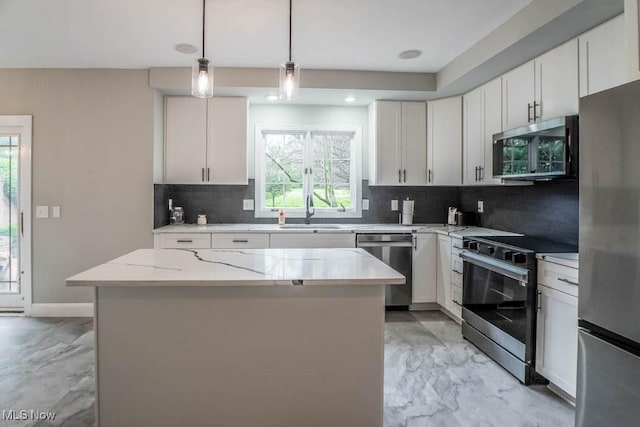 kitchen featuring stainless steel appliances, marble finish floor, white cabinets, backsplash, and a center island