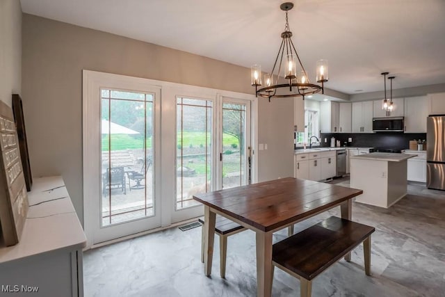 dining space featuring an inviting chandelier, visible vents, and marble finish floor