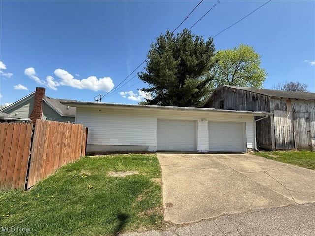detached garage featuring fence
