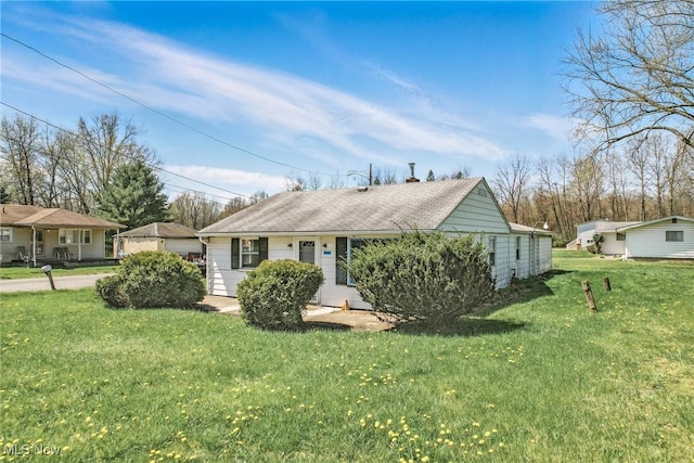 view of front of house with a chimney and a front yard