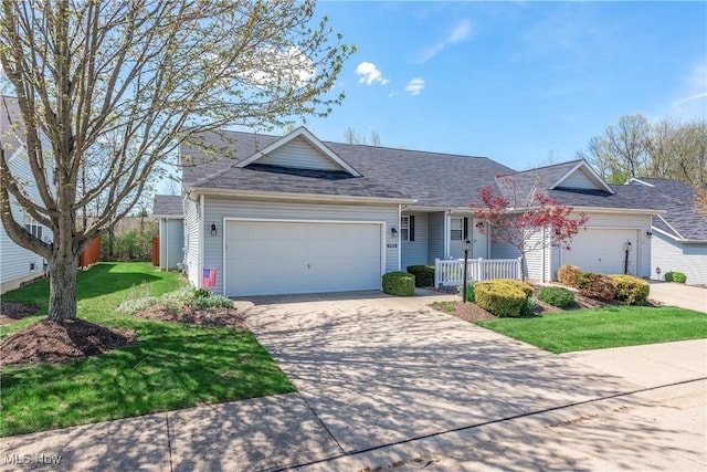 ranch-style house featuring a front yard, an attached garage, concrete driveway, and roof with shingles