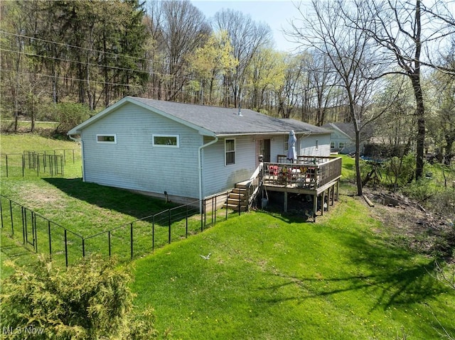 1966 Tall Timber Rd NE, New Philadelphia, OH 44663 - back of house with a lawn, a deck, stairs, and a fenced backyard
