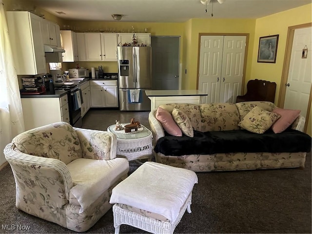 1966 Tall Timber Rd NE, New Philadelphia, OH 44663 - living area with dark colored carpet and ceiling fan