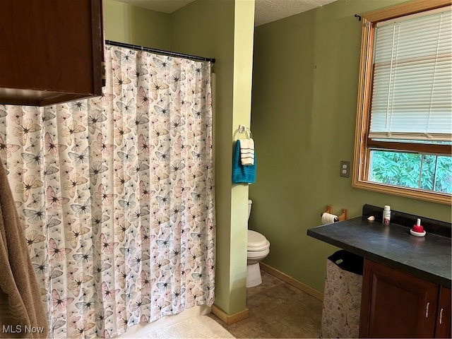 1966 Tall Timber Rd NE, New Philadelphia, OH 44663 - bathroom with curtained shower, toilet, and baseboards