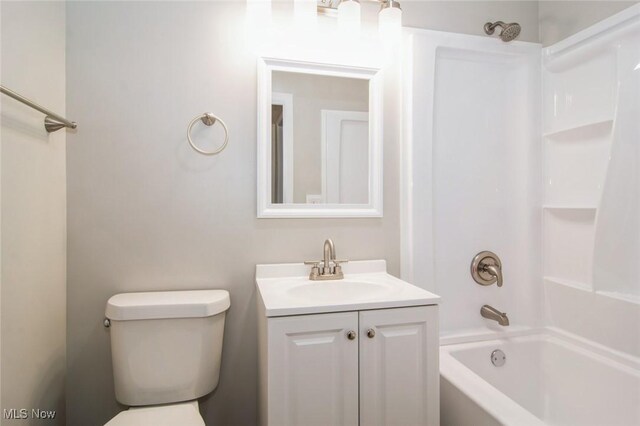 bathroom featuring toilet, shower / washtub combination, and vanity