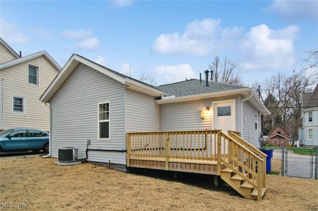 back of house featuring a wooden deck, a gate, a shingled roof, central air condition unit, and fence