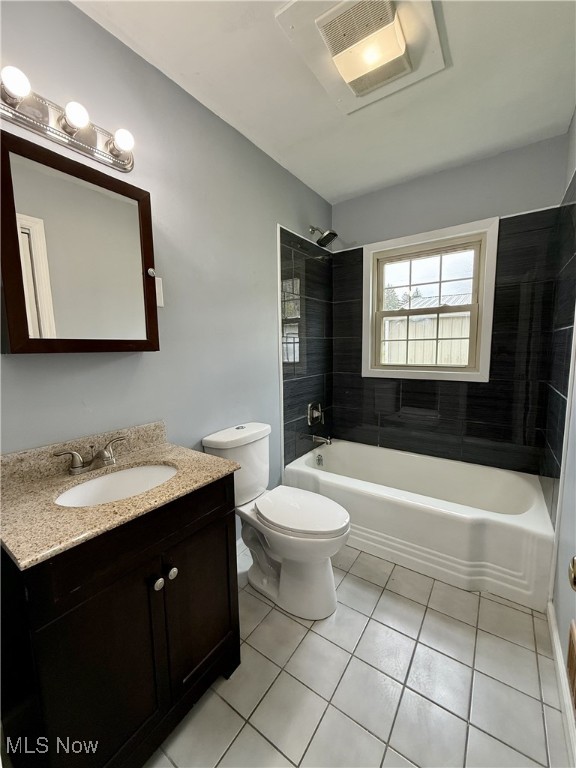 full bathroom featuring visible vents, toilet, vanity, tile patterned flooring, and bathtub / shower combination