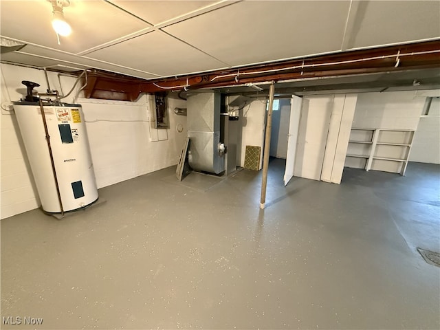 unfinished basement featuring heating unit, water heater, and electric panel
