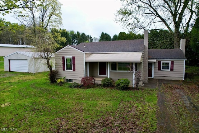 ranch-style home with a chimney, an outbuilding, a garage, roof with shingles, and a front lawn