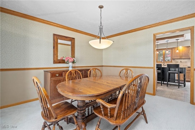 dining space featuring light colored carpet and crown molding