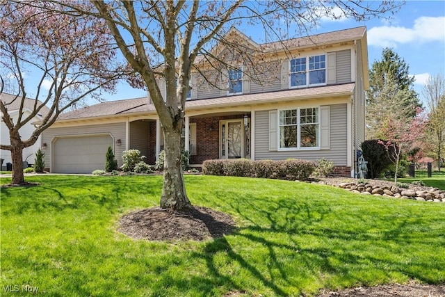 traditional home featuring a front lawn and an attached garage