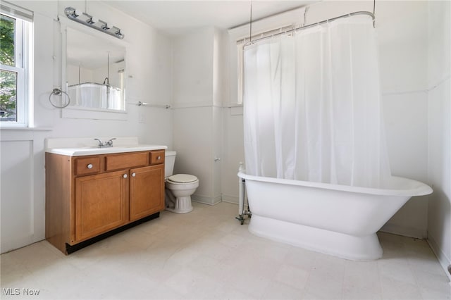 full bath with a soaking tub, a shower with shower curtain, toilet, and vanity