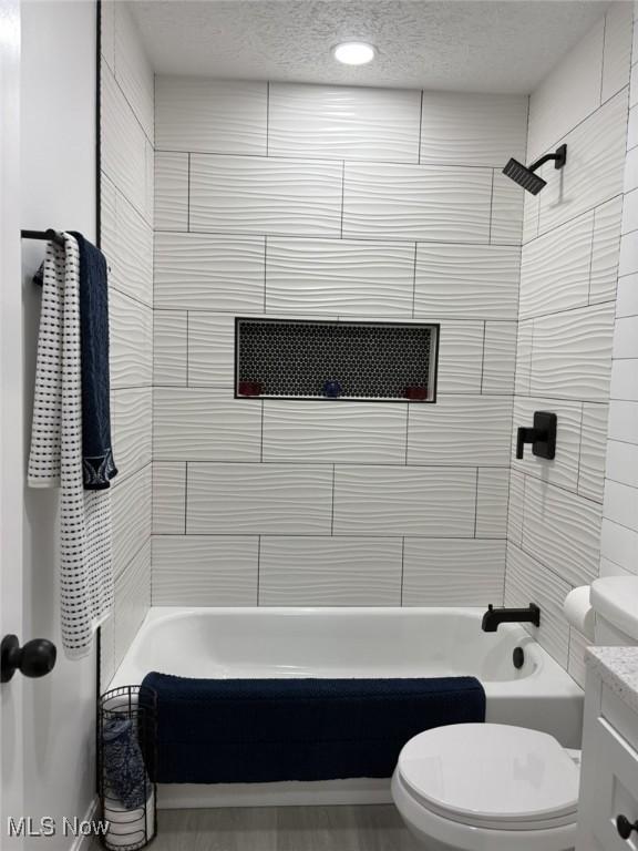 bathroom with a textured ceiling, shower / tub combination, vanity, toilet, and recessed lighting