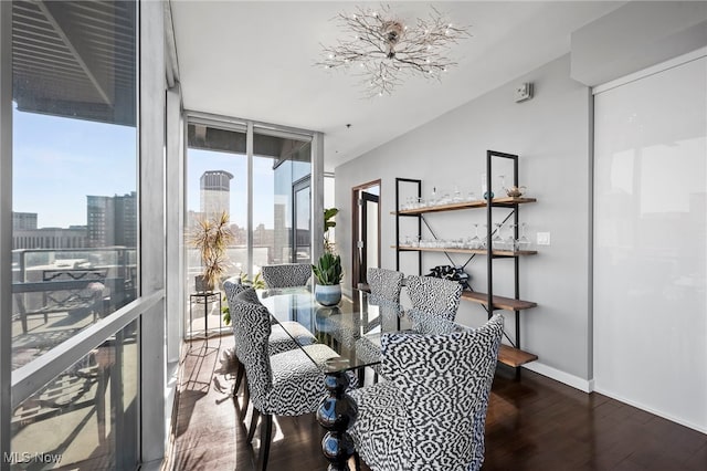 dining room featuring hardwood / wood-style floors, baseboards, expansive windows, and plenty of natural light