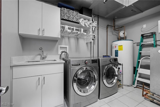 clothes washing area featuring water heater, separate washer and dryer, light tile patterned floors, cabinet space, and a sink