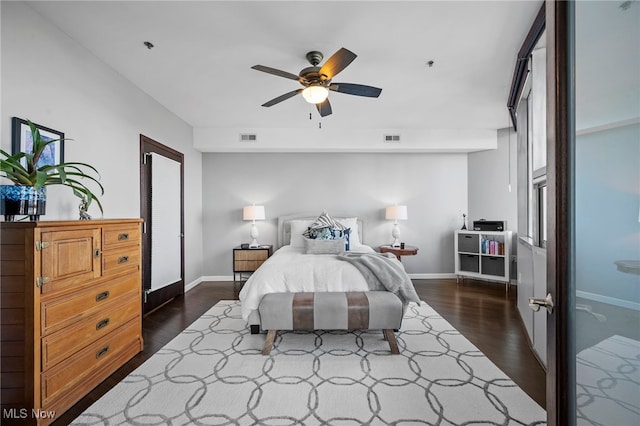 bedroom featuring baseboards, visible vents, and dark wood-style flooring