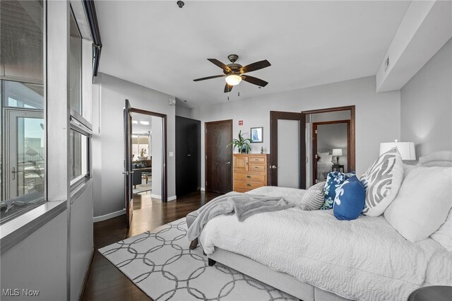 bedroom featuring dark wood-type flooring, ceiling fan, and baseboards