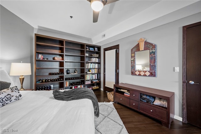 bedroom with baseboards, visible vents, ceiling fan, and dark wood-type flooring