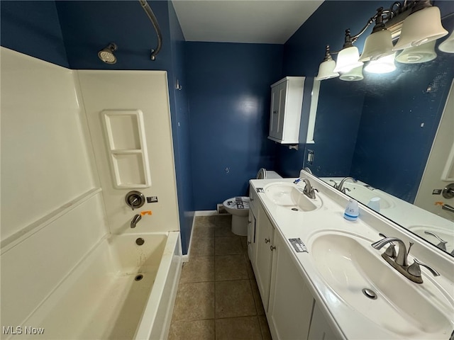 bathroom featuring toilet, tile patterned flooring, and a sink