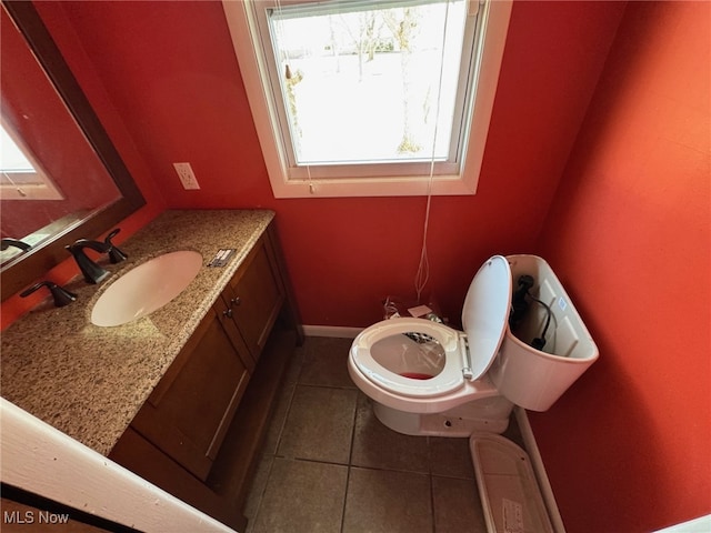 bathroom with vanity, tile patterned floors, and baseboards