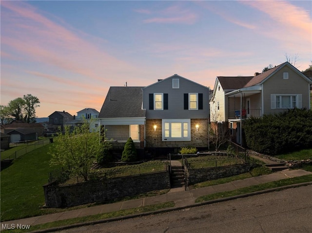view of front of property featuring a front lawn and a fenced front yard