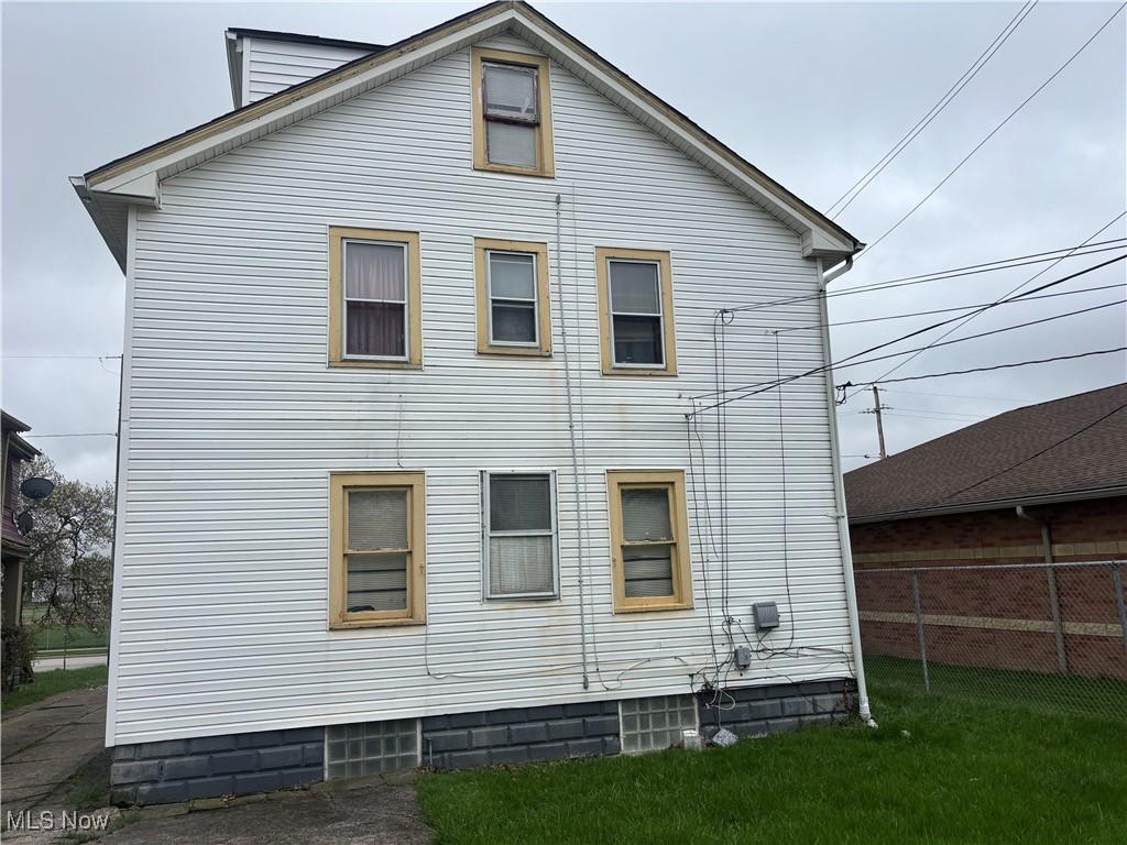 back of property featuring fence