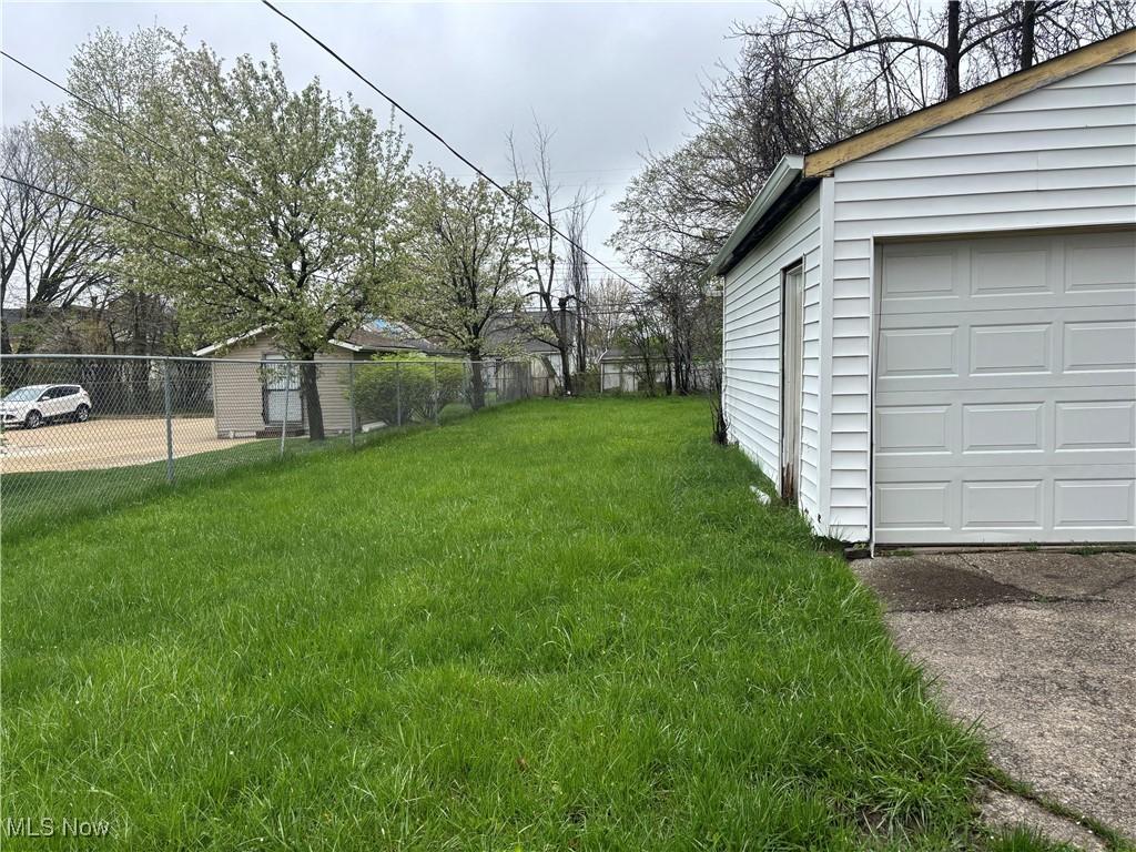 view of yard with a garage and fence