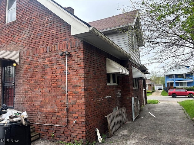 12608 Corlett Ave, Cleveland, OH 44105 - view of property exterior with a chimney and brick siding