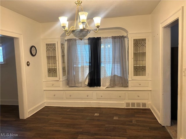 12608 Corlett Ave, Cleveland, OH 44105 - unfurnished dining area with a wealth of natural light, a notable chandelier, visible vents, and dark wood-type flooring