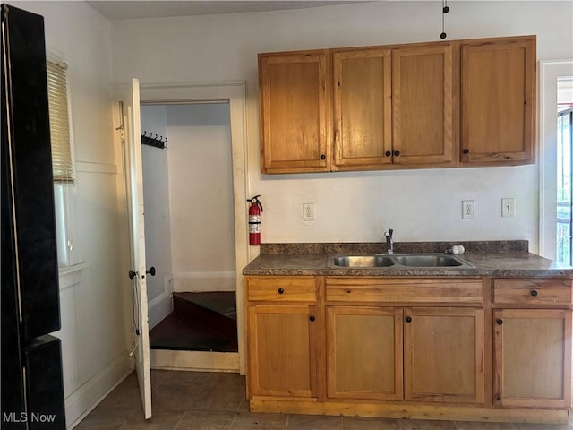12608 Corlett Ave, Cleveland, OH 44105 - kitchen with dark countertops, brown cabinets, and a sink