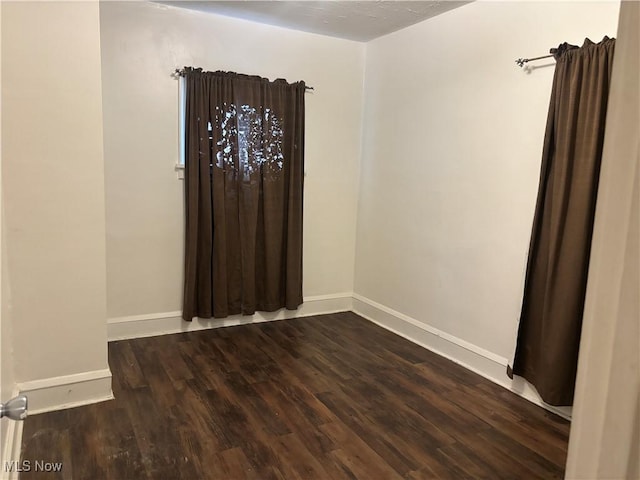 12608 Corlett Ave, Cleveland, OH 44105 - empty room with dark wood finished floors and baseboards