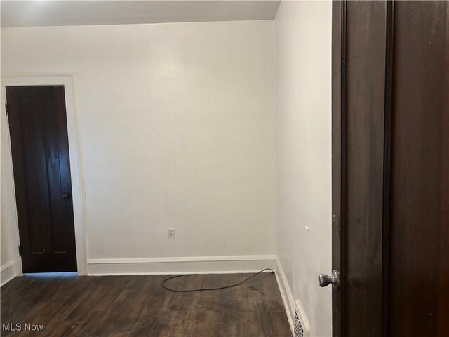 12608 Corlett Ave, Cleveland, OH 44105 - unfurnished room with dark wood-type flooring, baseboards, and visible vents